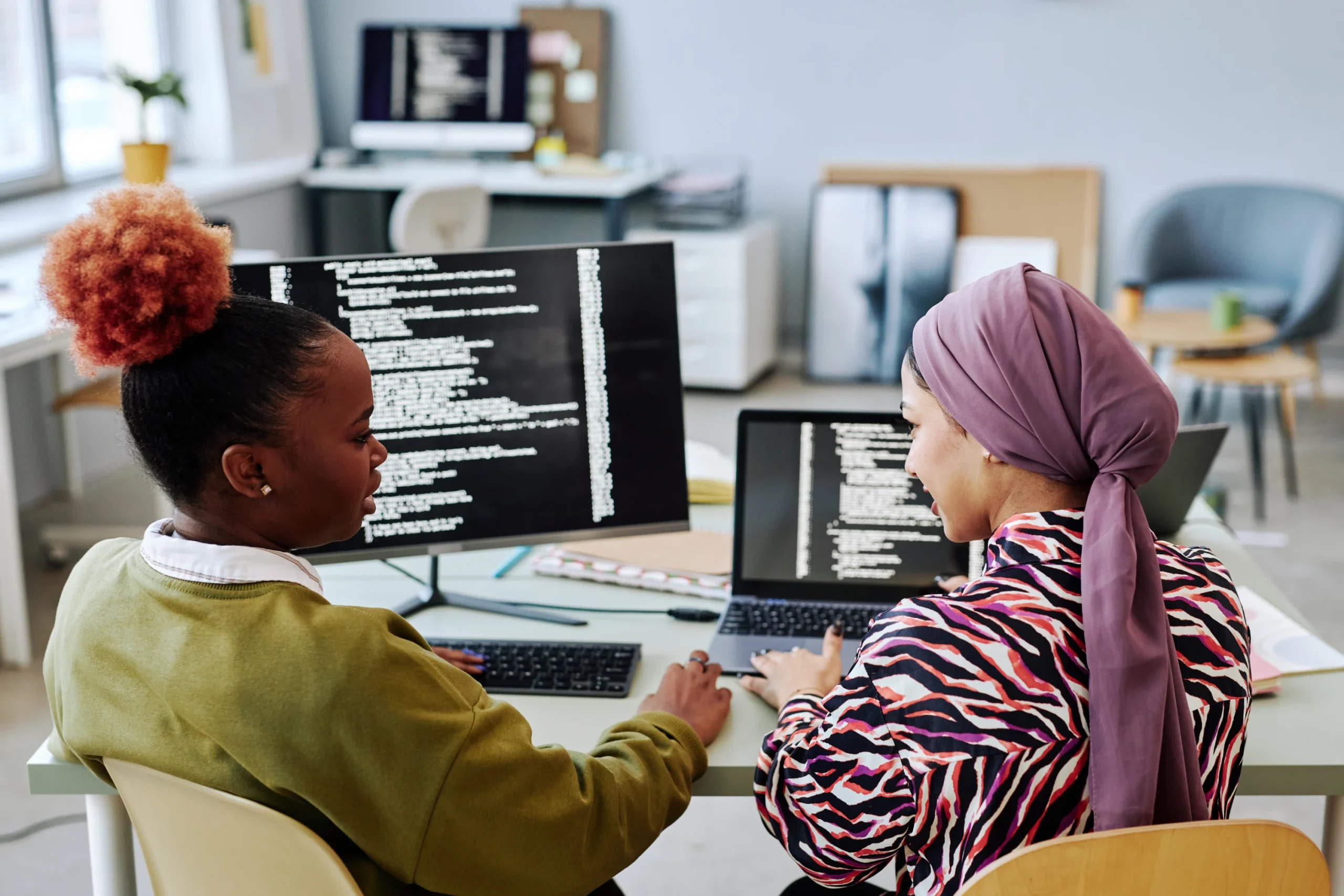 vivendis-groupe-back-view-at-two-female-programmers-writing-code-t-2026-01-08-06-39-41-utc